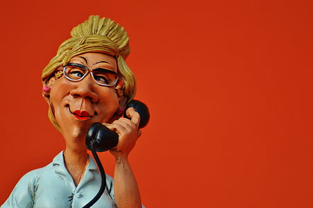 woman in blue top with telephone figurine thumbnail