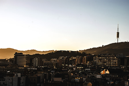 high-rise buildings near tower on mountain thumbnail