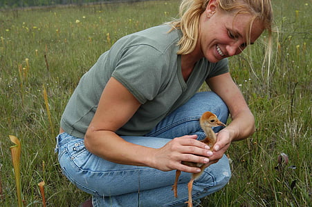 woman holding brown duckling thumbnail