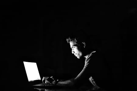silhouette photography of man in front of turned on laptop computer thumbnail