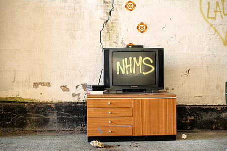 black CRT TV on wooden sideboard near wall thumbnail