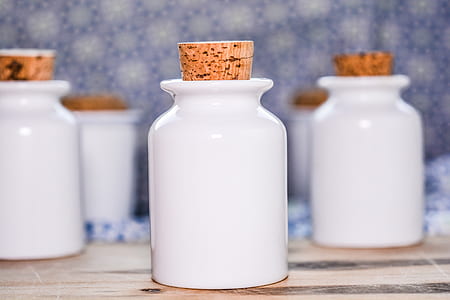 shallow focus photo of white container with cork thumbnail