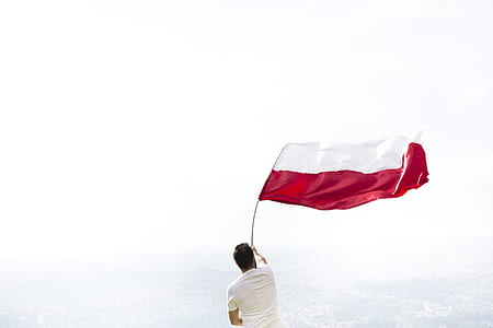 person waving white and red flag thumbnail
