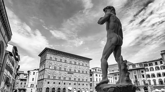 grayscale photo of Statue of David near buildings thumbnail