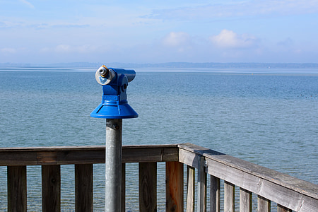 blue telescope beside railing overview of sea thumbnail