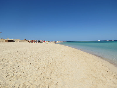 group of people walking on shore thumbnail