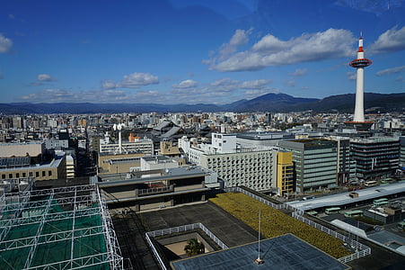 white and black concrete buildings under white and blue sky at daytime thumbnail