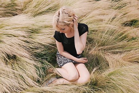 woman sitting on wheat field thumbnail