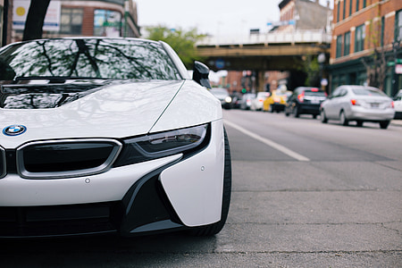 white BMW car parking on road thumbnail