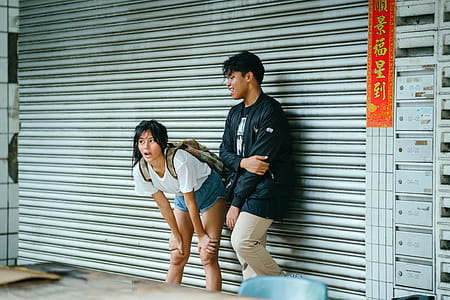 Man And Woman Standing In Front Of Metal Roll-up Door thumbnail