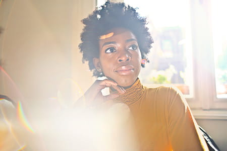 A young African woman wearing yellow dress posing indoors thumbnail
