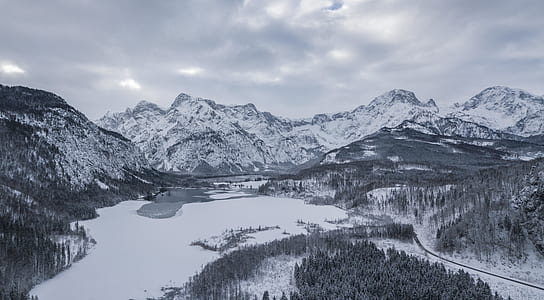 body of water near mountain filled with snow thumbnail