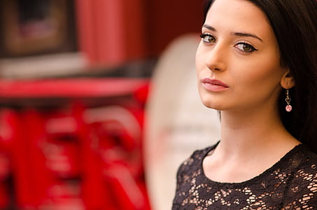 woman wearing black scoop-neck lace top standing inside well lighted room selective photography thumbnail