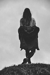 Grayscale Photography of a Woman With Her Legs Cross thumbnail