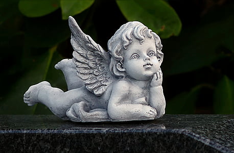 shallow focus photography of concrete cherub statue thumbnail