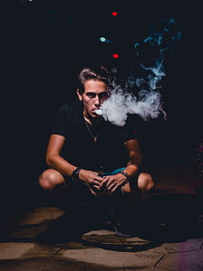 man smoking in the dark thumbnail