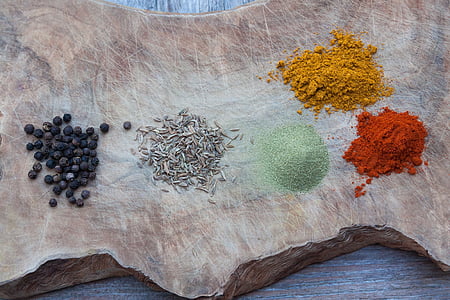 five assorted spices on wood slab thumbnail