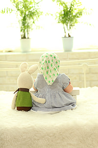 girl sitting beside plush toy thumbnail