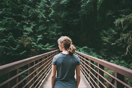 woman on bridge during daytime thumbnail