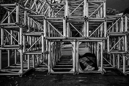 person sleeping under scaffolding thumbnail