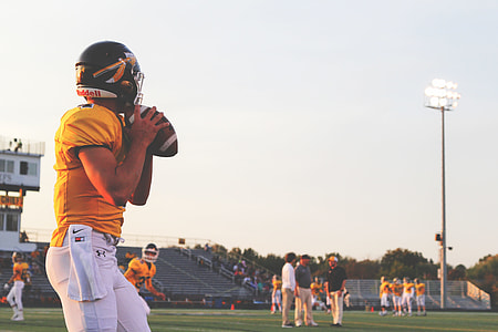 man playing American football during daytime thumbnail