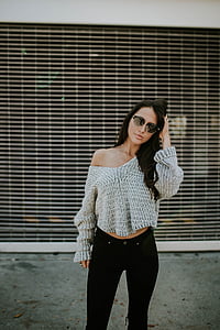 woman standing beside shutter roller thumbnail