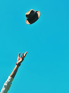 person throwing brown hat into the air thumbnail