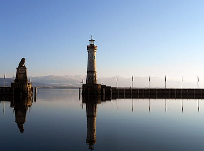 brown lighthouse under blue sky thumbnail