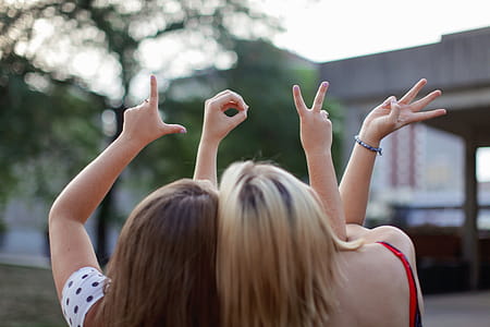 Two Women Making Love Hand Signs thumbnail