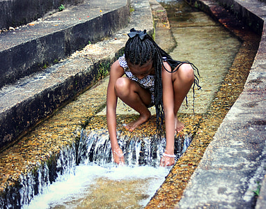 girl on floating water during daytime thumbnail