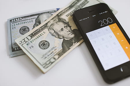 Counting Dollars on calculator on smartphone thumbnail