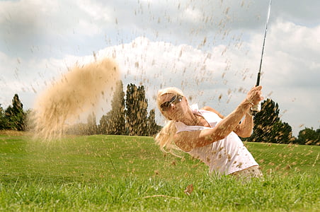 photograph of woman holding golf driver in green grass field thumbnail