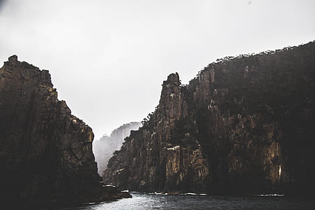 brown concrete mountain and body of water thumbnail