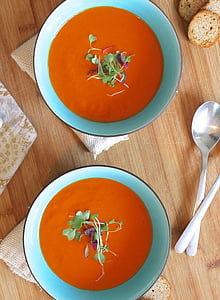 two orange soups on teal ceramic bowls thumbnail