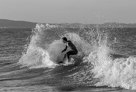 Grayscale Photo of Man Surfing thumbnail