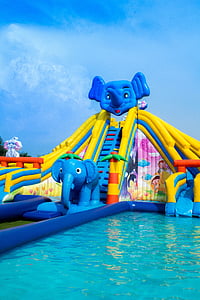 yellow and blue elephant inflatable slide at daytime thumbnail