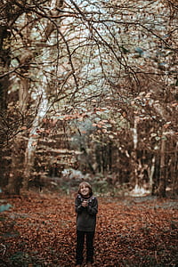 boy standing on dried leaves thumbnail