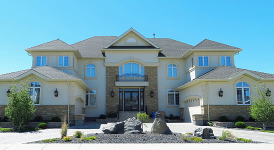 white and brown concrete house under blue sky during daytime thumbnail