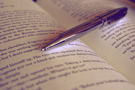 gray click pen on open book thumbnail