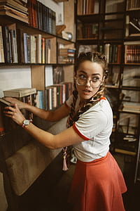 woman putting books on shelf thumbnail