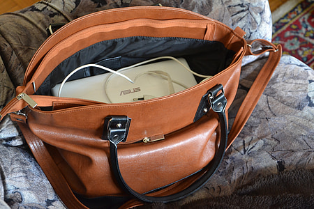 white Asus laptop on brown leather bag thumbnail