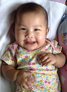 baby wears multicolored floral onesie thumbnail