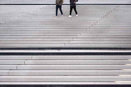 two people walking down on stairs at daytime thumbnail