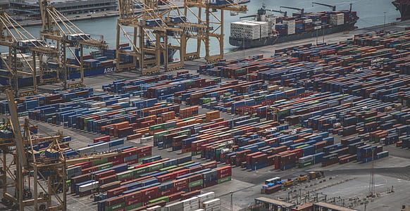 aerial photography of shipment containers beside body of water at daytime thumbnail