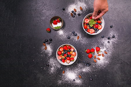 two round white and one brown bowls with strawberries and blue berries thumbnail