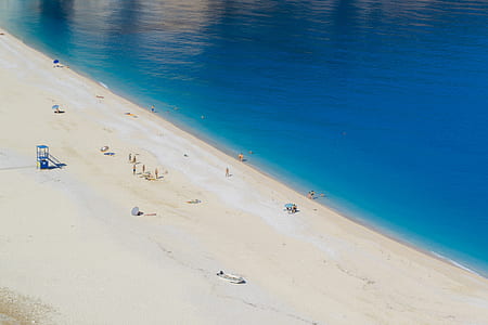 aerial photography of people on beach at daytime thumbnail