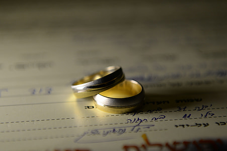 silver-colored wedding ring set on white surface thumbnail