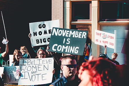 People Holding Banner Near Building thumbnail