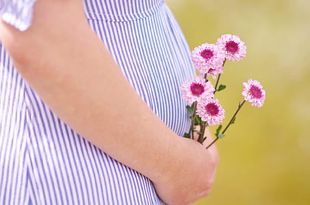 person holding pink flowers thumbnail