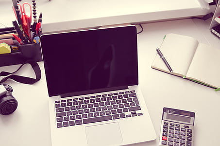 white and black laptop computer near desktop calculator thumbnail
